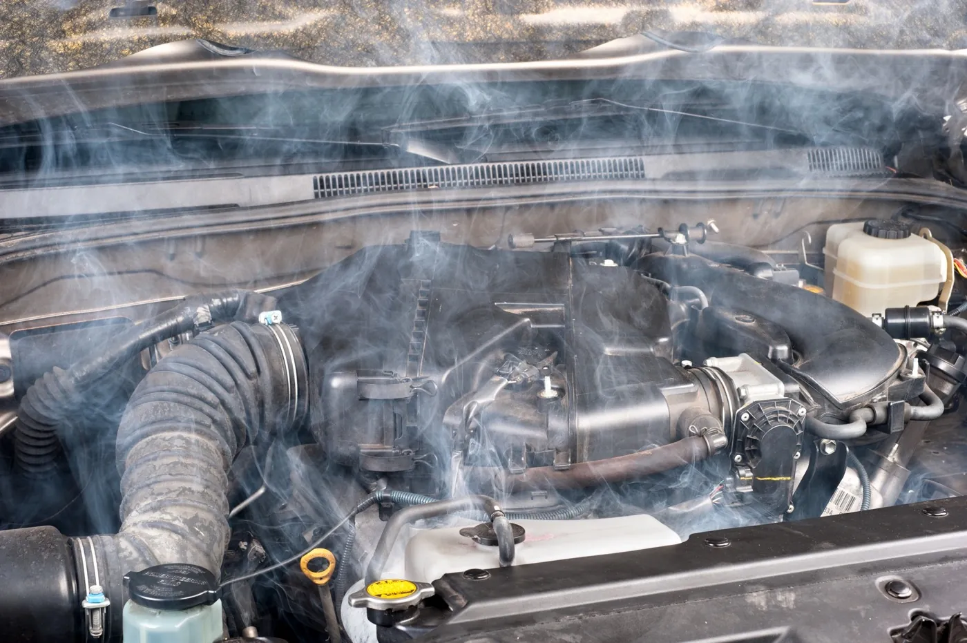 Engine bay of a vehicle being diagnosed at Titan Auto Services