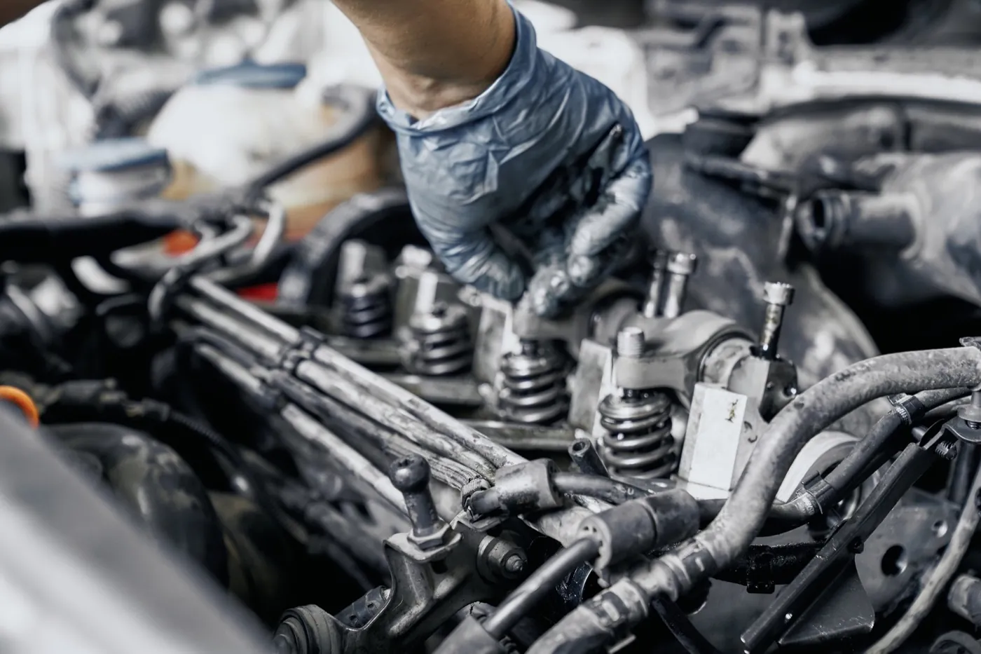 Close-up of fuel injector nozzles in an engine under an open hood