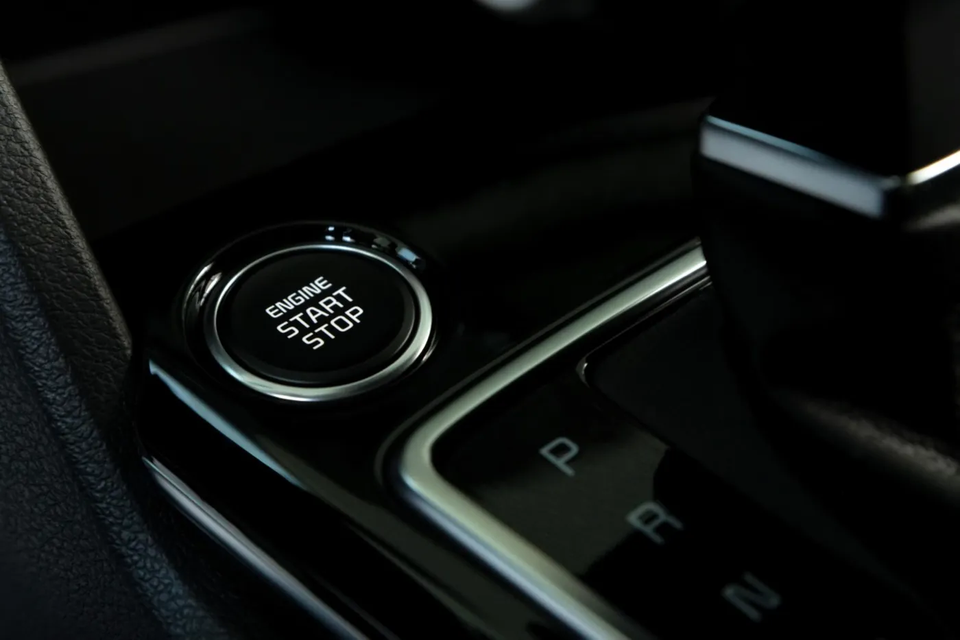 Driver pressing the engine start button in a car that will not start